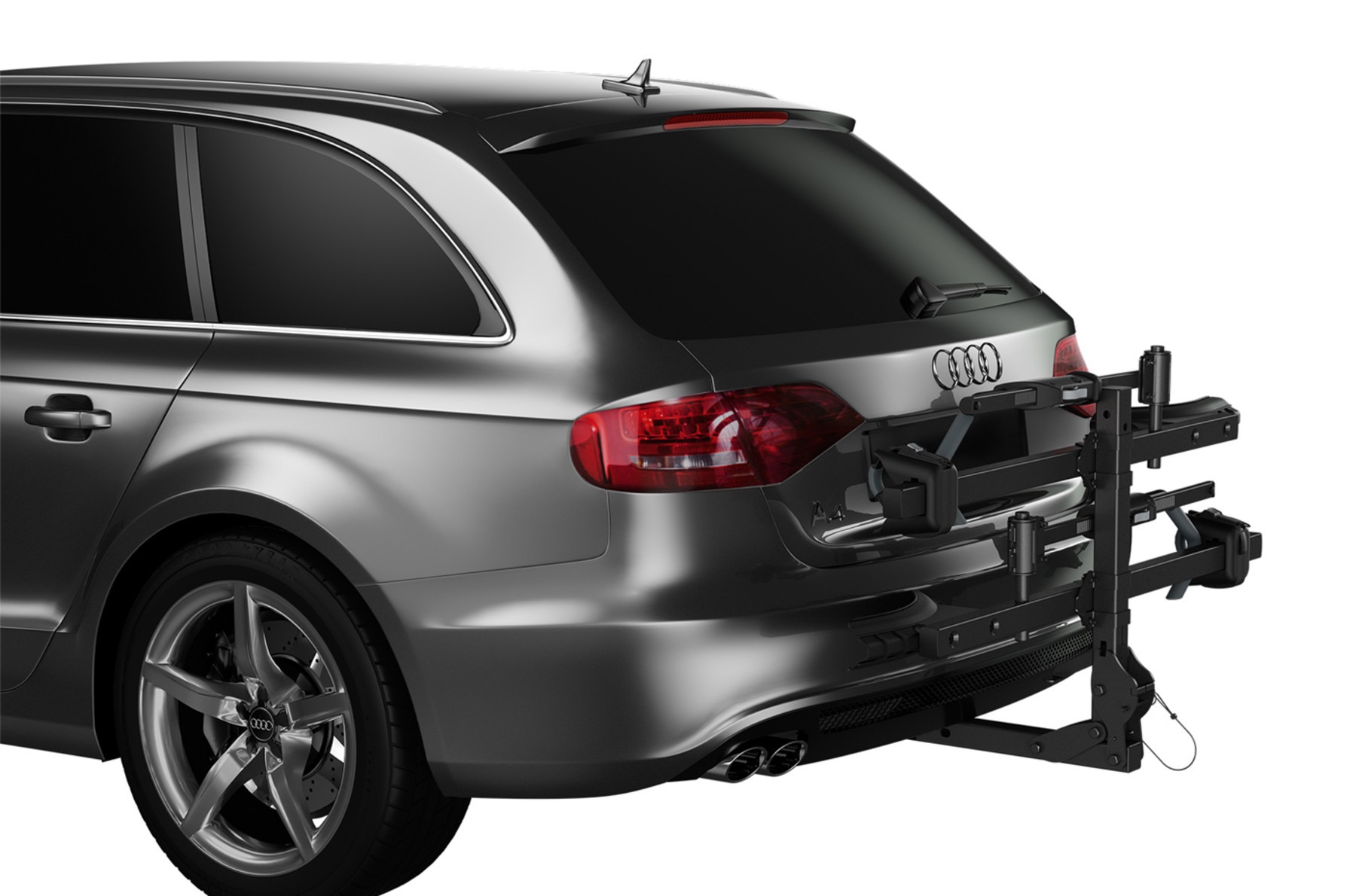Hitch-mounted bike rack attached to the rear of a silver Audi station wagon, shown without bikes loaded